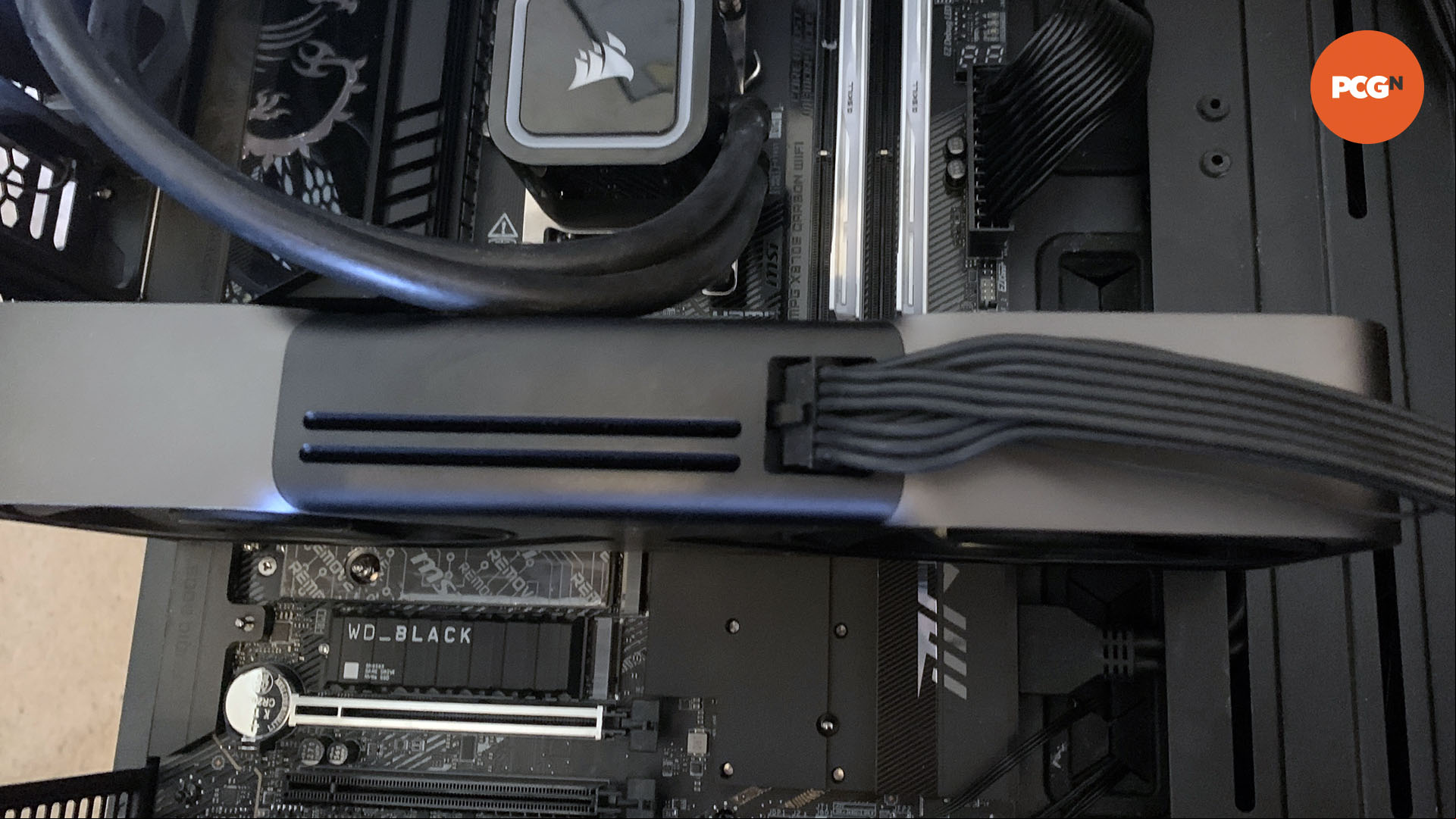 How to install a graphics card: Nvidia GeForce RTX 5090 installed with cable plugged in.