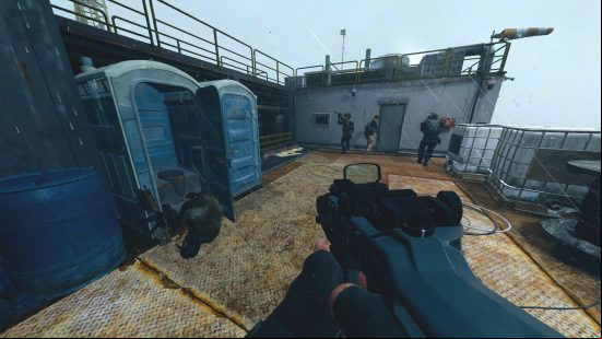 How to kill the enemy in the porta-potty: a solider looks on at a dead body, slumped on a toilet