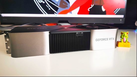 Nvidia RTX 4080 graphics card sitting horizontal on white desk
