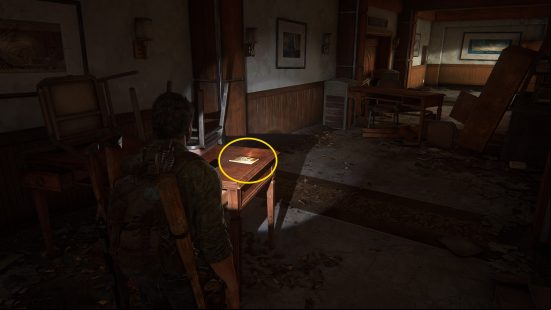 The Last of Us training manuals: a man finds a book on a table.