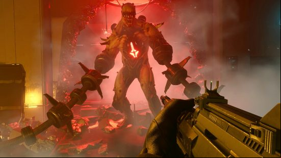 Killing Floor 3 details: A large Fleshpound leaves a hole in the wall behind him, as long spiked arm attachments trail on the floor and the player points a gun towards it.