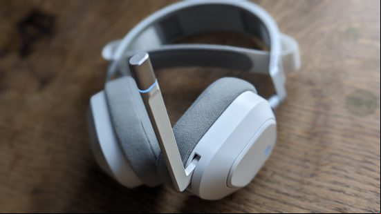 Corsair HS80 Max review: a white headset with extended microphone appears on a wooden table.