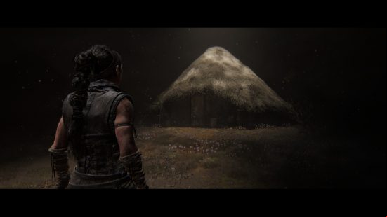 Hellblade 2 preview: Senua approaches her childhood home in her mindscape, a small hut surrounded by flowers.