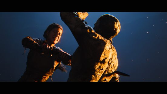 Hellblade 2 preview: Senua grits her teeth in effort as she drives her sword through a Northman painted in mud and clay.