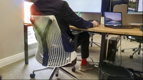 A person sitting in the Herman Miller Sayl office chair