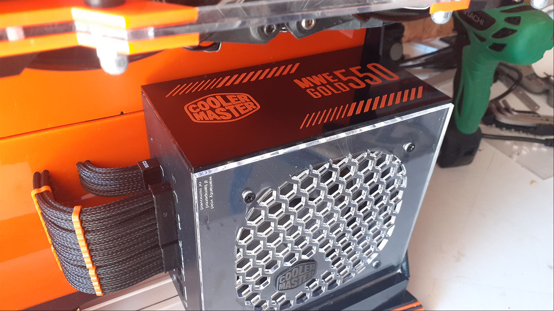 The PSU mounted to the plastic frame of the mini gaming PC