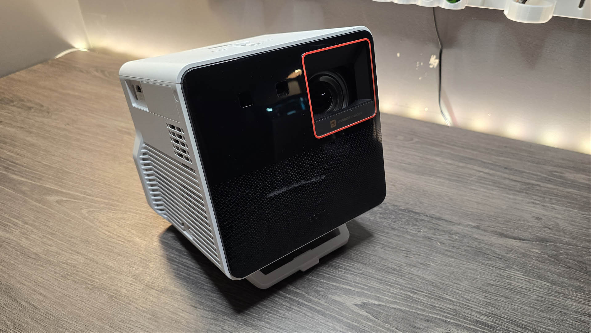 The the Benq 300G gaming projector on a wooden desk